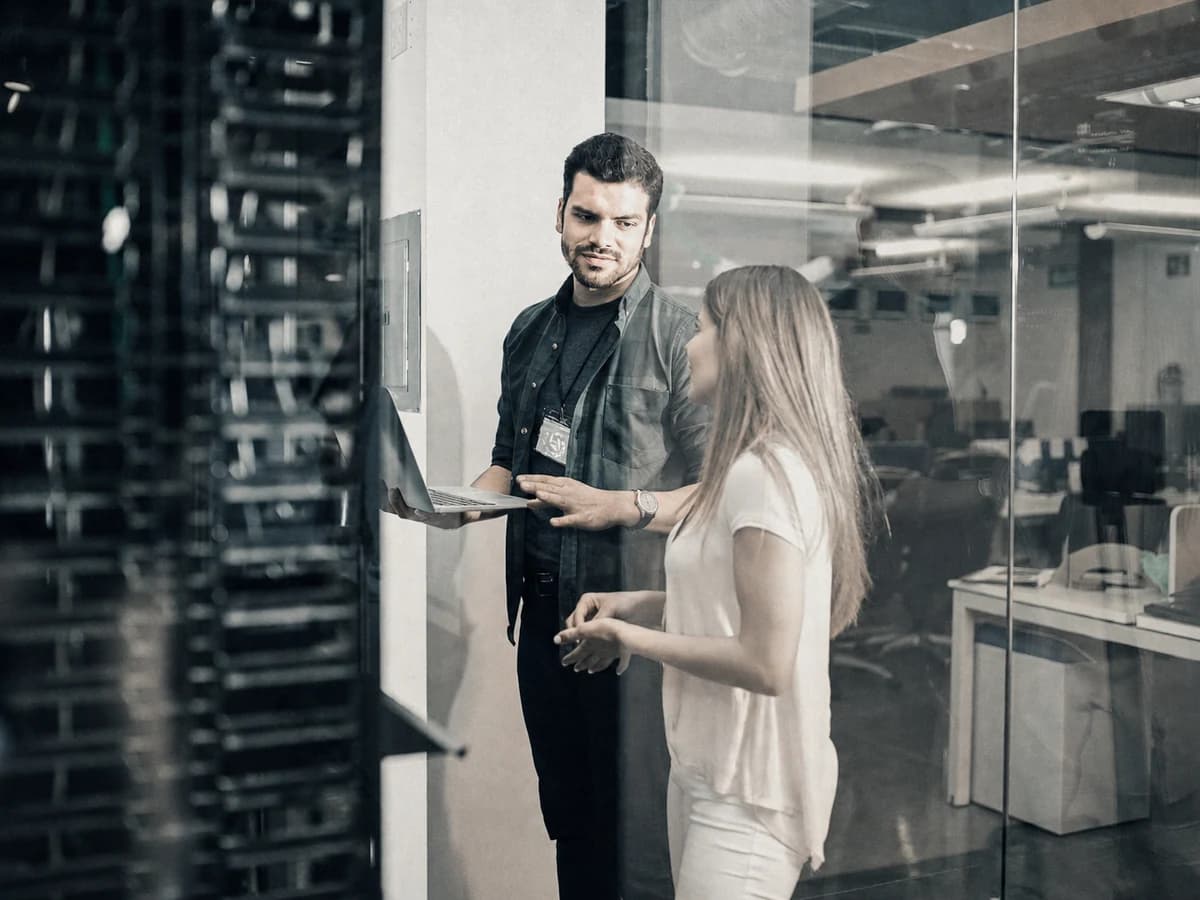 Information technology professionals reviewing infrastructure in a server environment